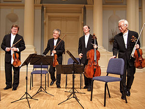A modern string quartet. In the 2000s, string quartets from the Classical era are the core of the chamber music literature. From left to right: violin 1, violin 2, cello, viola Tokyo String Quartet.jpg