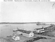 US Naval Academy waterfront in the late 1860s with the barrack/school ships USS Constitution and Santee tied up in the background. Other ships not identified. USNA-Constitution&Santeelate1860s.jpg