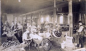 Workers assembling transmissions at St. Louis Motor Carriage Company factory