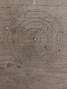 Circular marks above a fireplace