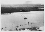 Anti-submarine boom (net) at Fort Lytton during the Second World War. Two moving boom gates were operated by winches located at the fort and on the permanently anchored ship. [gallery 12]