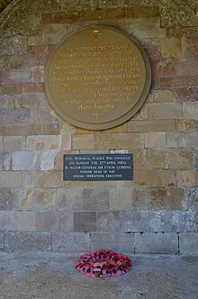 SOE memorial plaque in the cloister of Beaulieu Abbey, Hampshire, unveiled by Major General Gubbins in April 1969 Beaulieu SOE Memorial.jpg
