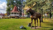 photo of town square on a sunny day with a life-sized moose and a gazebo