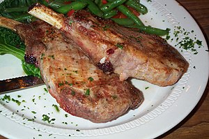 Pork chops, cooked and served.