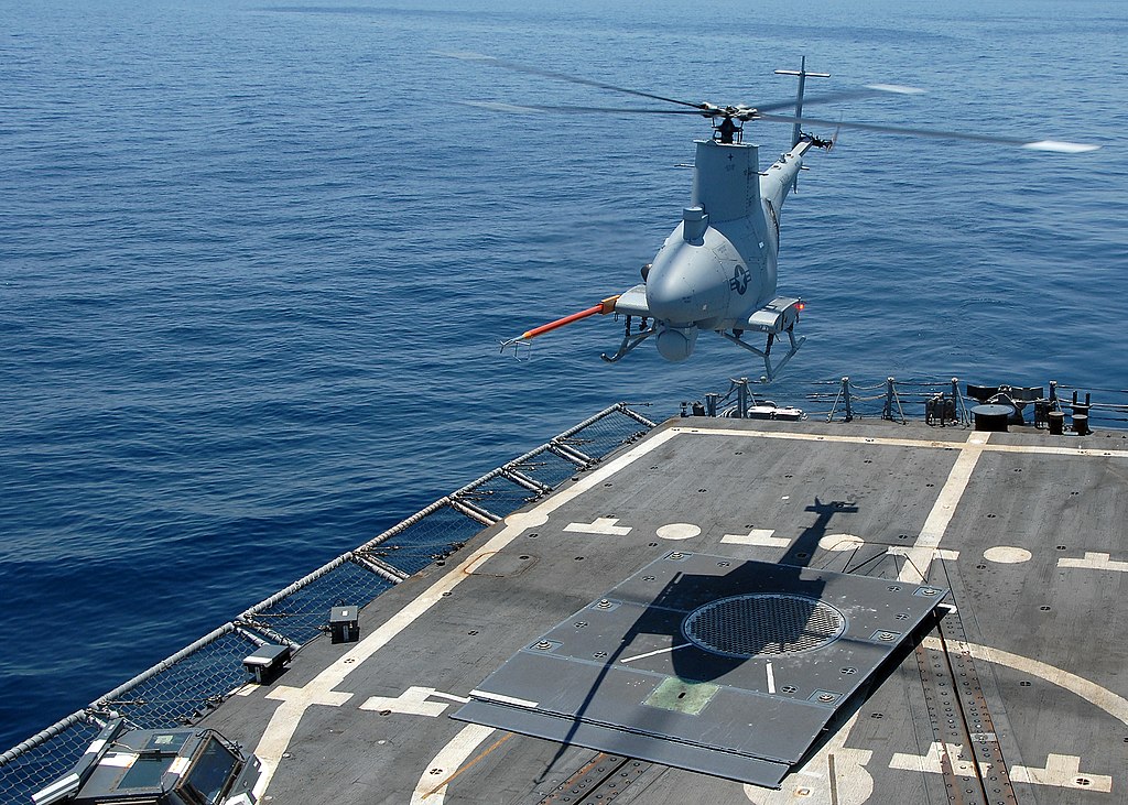 http://upload.wikimedia.org/wikipedia/commons/thumb/6/64/US_Navy_090508-N-2821G-146_The_Northrop_Grumman_Corporation-developed_Unmanned_Aerial_Vehicle_MQ-8B_Fire_Scout_hovers_over_the_flight_deck_of_the_guided-missile_frigate_USS_McInerney_(FFG_8).jpg/1024px-thumbnail.jpg