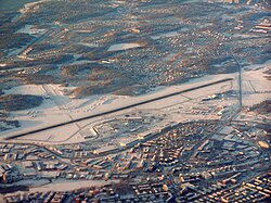 Bromma kyrka, från luften norrifrån, med Bromma flygplats i förgrunden