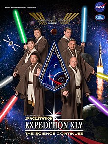 Expedition 45 crew poster - based on Star Wars theme; Lindgren is at bottom left, holding red lightsaber Expedition 45 'Return of the Jedi' crew poster.jpg