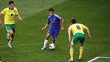 Eden Hazard in possession of the ball during a 2012 match between Chelsea and Norwich City Hazard taking on Howson.jpg