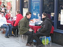 A Scientologist administers a stress test using an e-meter. Scientology Free Stress Test.jpg