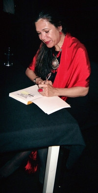 Ana Castillo signing a copy of Massacre of the Dreamers, May 25, 2006 Ana-Castillo.png