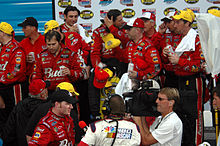 Dale Earnhardt Jr. (bottom), and team in victory lane in 2004 Dale Earnhardt Jr and team in the winners circle photo D Ramey Logan.jpg