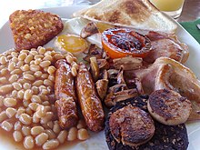 The full breakfast is among the best known British dishes, consisting of fried egg, sausage, bacon, mushrooms, baked beans, toast, fried tomatoes, and sometimes white or black pudding. Englishbreakfast.jpg