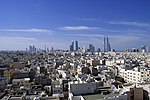 Skyline of Manama with traditional buildings and skyscrapers in the distance