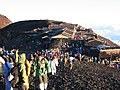 Buildings and hikers at the summit of Mount Fuji