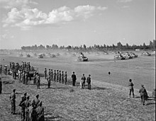 Small photo of tanks kicking up clouds of dust