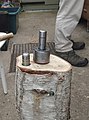 A peening jig anvil. Note the two colour-coded caps.