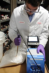 A US Food and Drug Administration scientist uses a portable near-infrared spectroscopy device to inspect lactose for adulteration with melamine Portable Screening Devices (1435) (8225044148).jpg
