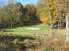 Water hazard, sand trap, and dense vegetation on the 13th hole at Ridgefield Golf Course, Connecticut Ridgefieldgolfcourseholenumbertwelve.jpg