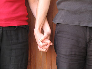 Holding hands symbolize registrated partnership.