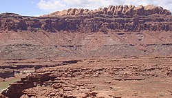 The Permian through Jurassic strata in the Colorado Plateau area of southeastern Utah demonstrate the principles of stratigraphy. These strata make up much of the famous prominent rock formations in widely spaced protected areas such as Capitol Reef National Park and Canyonlands National Park. From top to bottom: Rounded tan domes of the Navajo Sandstone, layered red Kayenta Formation, cliff-forming, vertically jointed, red Wingate Sandstone, slope-forming, purplish Chinle Formation, layered, lighter-red Moenkopi Formation, and white, layered Cutler Formation sandstone. Picture from Glen Canyon National Recreation Area, Utah. SEUtahStrat.JPG