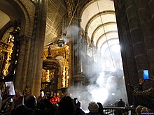 The giant Botafumeiro thurible swinging from the ceiling of the Cathedral of Santiago de Compostela Santiago de Compostela (40305048451).jpg