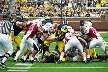 The University of Massachusetts Minuteman playing with Michigan Wolverines in 2010. UMass at Michigan (5002255089).jpg