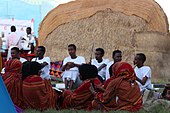 Somali men and women in front of a traditional house University students sits in front of Somali traditional house.jpg