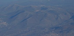 Aerial view of the hills North of Orahovac with the small village in the centre