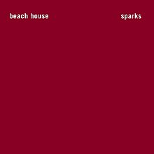 White text showing "Beach House" and "Sparks", all in lowercase, in front of a cherry red background.