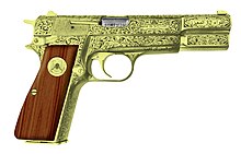 A gold-plated and engraved Browning Hi-Power handgun. Of the few created, one of these models was in the possession of Gaddafi during the attack and later appropriated by rebels after his death. The engraving references the Khamis Brigade. FNBrowningHP32ndRB.jpg