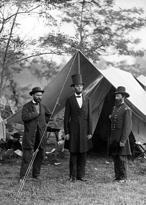 Lincoln, in a top hat, with Allan Pinkerton an...