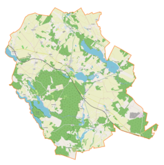 Mapa konturowa gminy Rybno, blisko centrum na prawo u góry znajduje się owalna plamka nieco zaostrzona i wystająca na lewo w swoim dolnym rogu z opisem „Jezioro Rumiańskie”