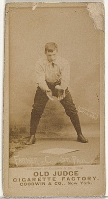 Standing man in baseball uniform catching a ball