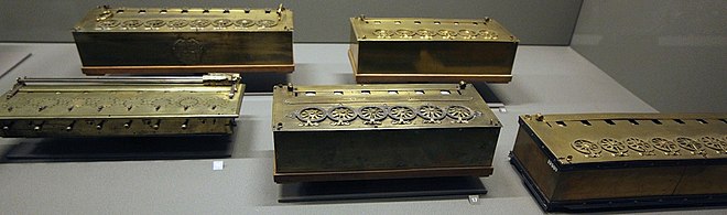 Four of Pascal's calculators and one machine built by Lepine in 1725, Musee des Arts et Metiers 17th-century-mechanical-calculators -Detail.jpg