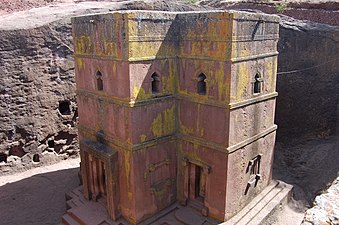 Large, monolithic churches such as the Church of Saint George (Lalibela), were hewn out of the ground in Ethiopia, unknown architect, late 12th or early 13th century