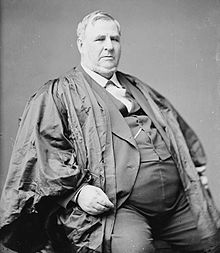 Davis seated in a robe