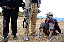 Three Maoist rebels wait on top of a hill in the Rolpa District for orders to relocate. Maoist rebels on a hill in Nepal.jpg