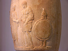 Funerary loutrophoros; on the right, a bearded slave carries his master's shield and helm, 380-370 BC, National Archaeological Museum of Athens NAMA Loutrophoros Polystratos.jpg