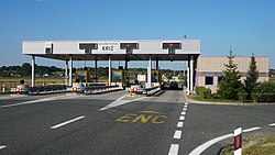Toll plaza booths with variable traffic signs placed over the toll gates.
