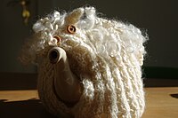 Teapot with knitted tea cosy sheep