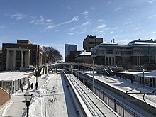 East Bank campus in winter. Ford Hall on the left, Nils Hasselmo Hall on the right of the light rail in the picture. University of Minnesota.jpg