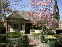 Example of Arts and Crafts style influence on Federation architecture Observe the faceted bay window and the stone base. 7 Boomerang St Haberfield 044-M.jpg