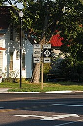 A road sign assembly showing a To plate over a County Road 480 sign and a Business plate over an M-28 sign. Both feature right arrows indicating that Business M-28 turns right and runs to a connection with County Road 480.