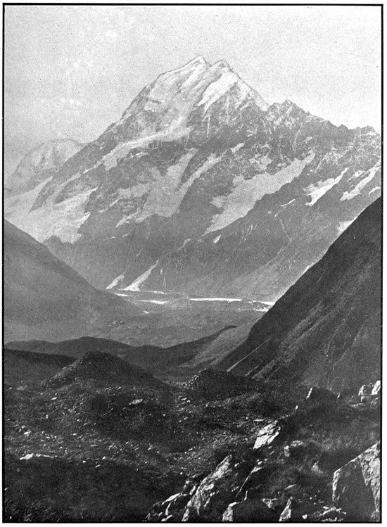 Aorangi / Mount Cook with partial snow cover on the lower slopes and rough rocky terrain in the foreground