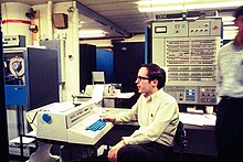 Computing Center staff member Mike Alexander sitting at the console of the IBM System 360 Model 67 Duplex at the University of Michigan, 1969 IBM360-67AtUmichWithMikeAlexander.jpg