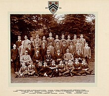 John Middleton, Winchester College, seated on chair, 3rd from left wearing cricket cap worn when playing in the 1914 Eton Match J.A. Middleton at Winchester 1914.jpg