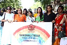 A Sambhali members walking with sign during Jodhpur pride.