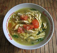 Soto ayam, chicken soto in soup with turmeric and spices