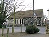 A flint and stone church with a tiled roof