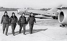 Vietnam People's Air Force pilots walk by their aircraft, the MiG-17. The development of the North Vietnamese Vietnam People's Air Force (VPAF) during the war was assisted by Warsaw Pact nations throughout the war. Between 1966 and 1972 a total of 17 flying aces was credited by the VPAF against US fighters. VPAF pilots with MiG-17s.jpg